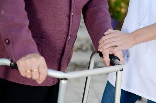 A person walking with a walker